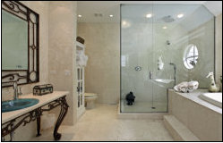 Marble bathroom with walk-in glass shower and traditional washstand